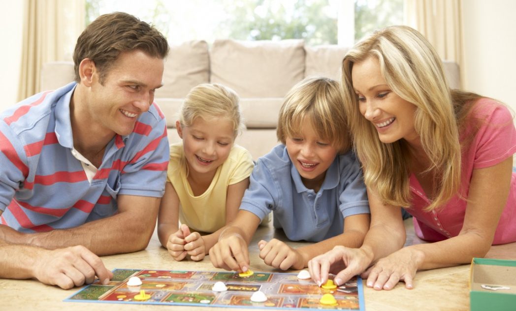 Family Playing Board Game At Home